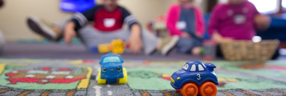 Preschoolers playing with cars