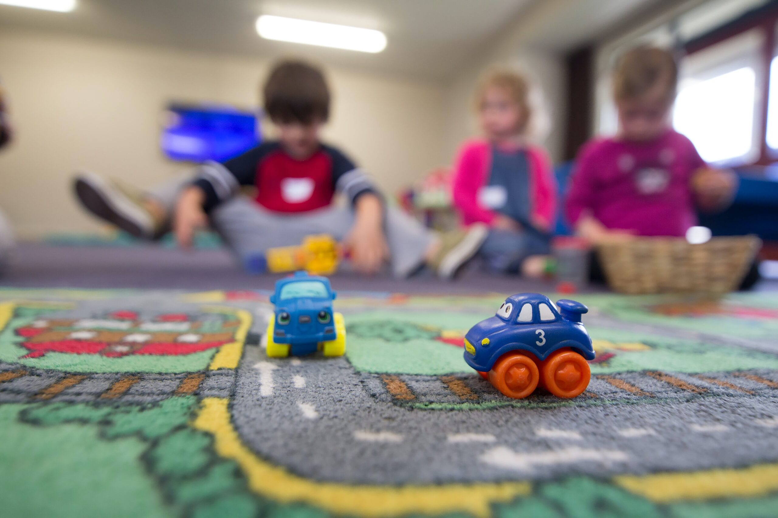 Preschoolers playing with cars