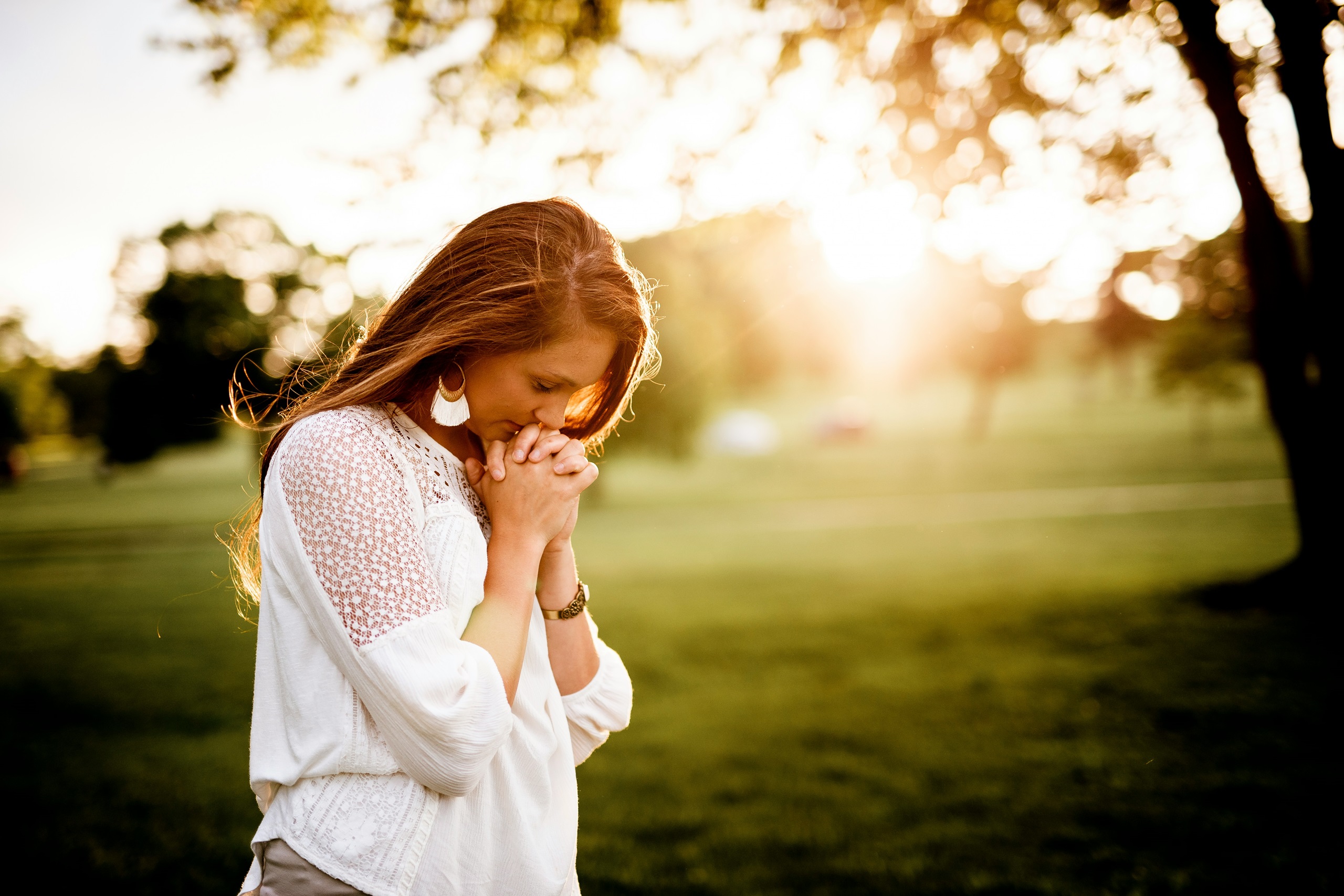 A woman praying outside