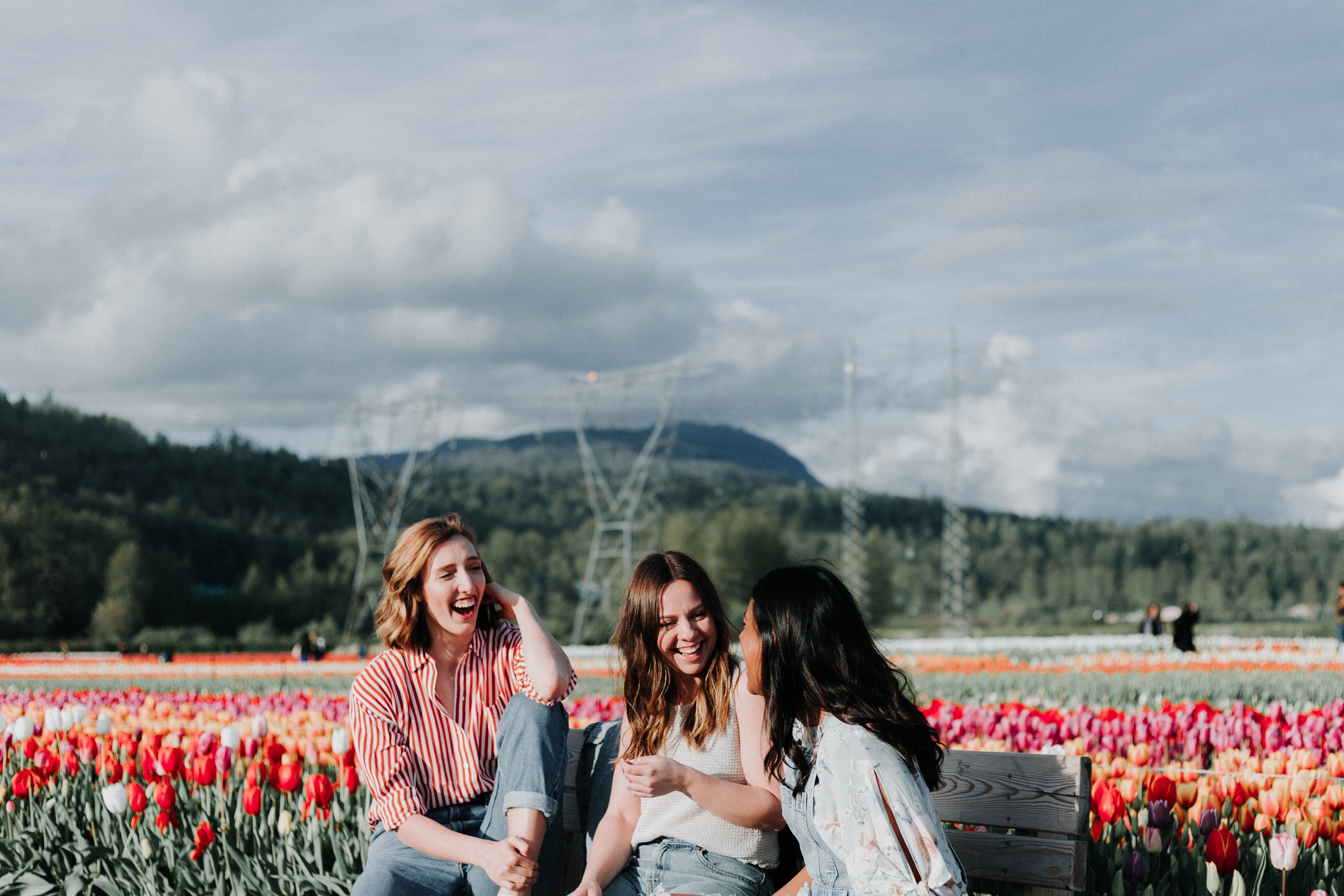 Women laughing near a tulip field