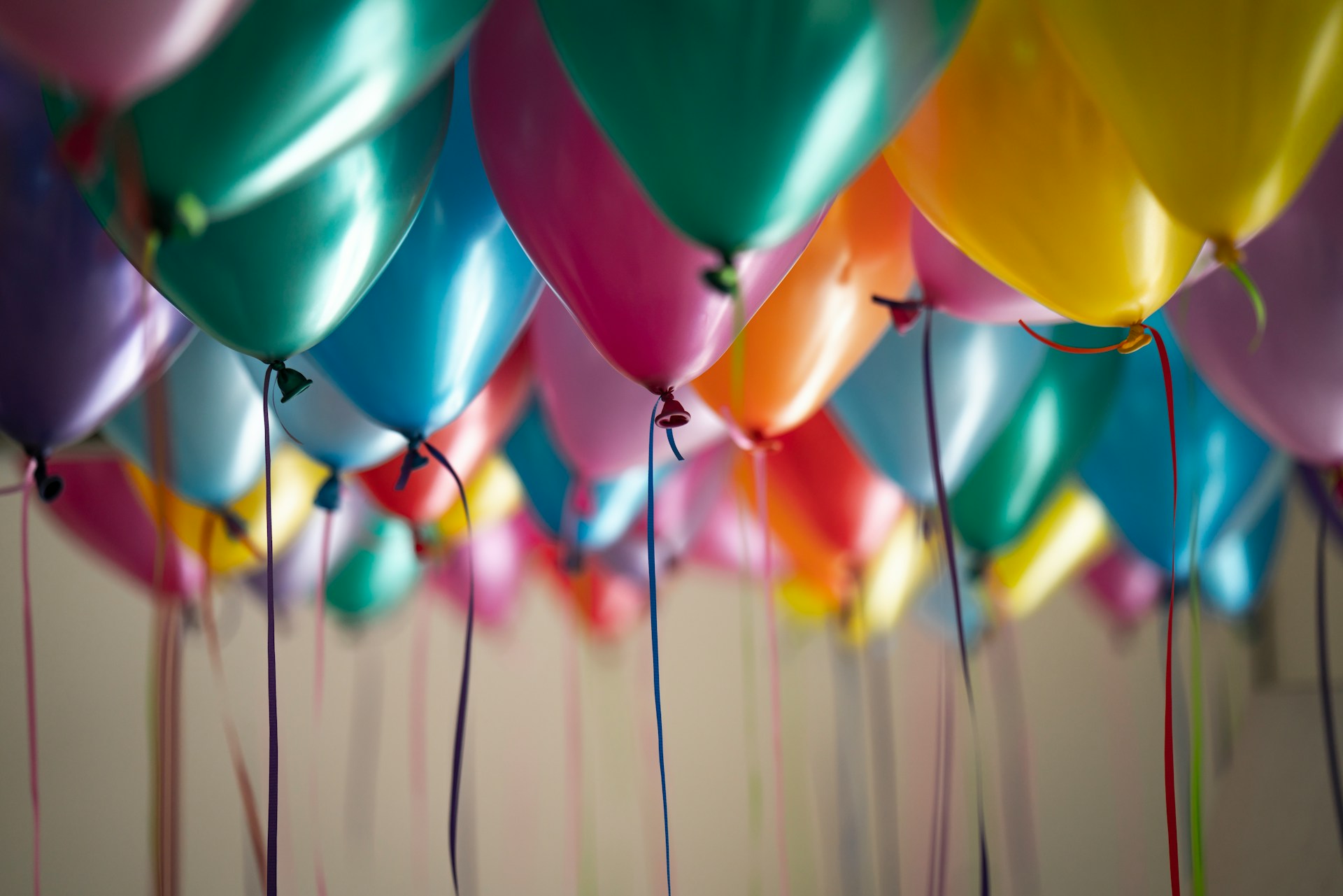 Various colored balloons floating in a room